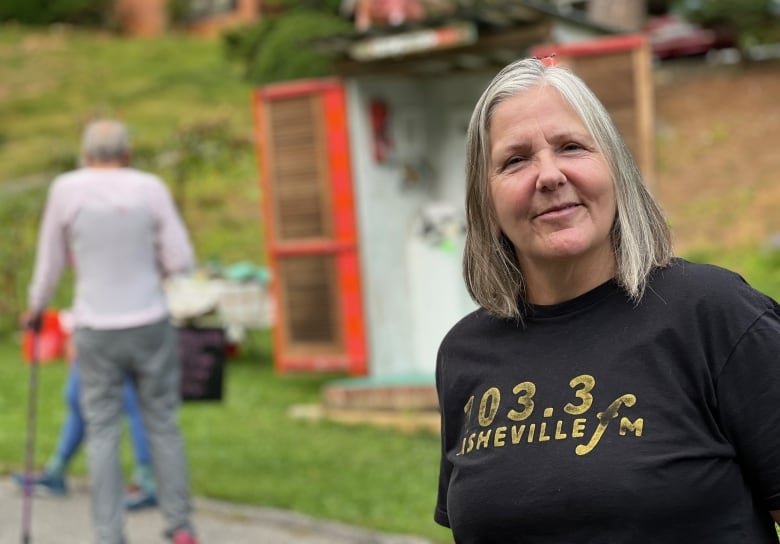 Woman on sidewalk in front of large property