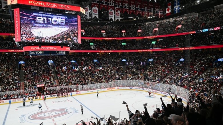 Fans at the Bell Centre in Montreal cheer as the attendance number is displayed on the big screen during a PWHL game on April 20, 2024.