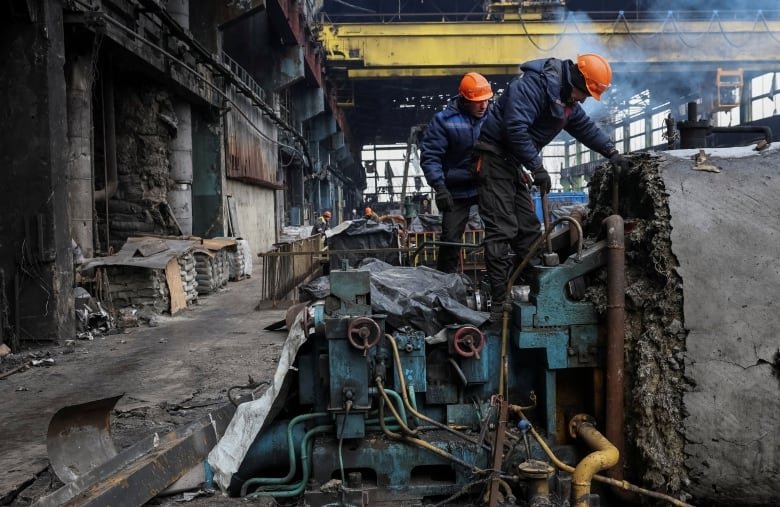 Workers fix a thermal power plant damaged by a Russian missile strike, amid Russia's attack on Ukraine, at an undisclosed location in Ukraine November 28, 2024.