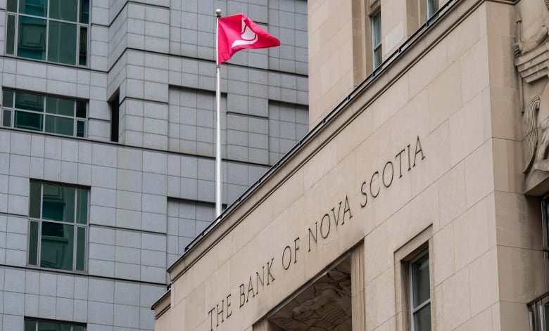 A flag flies above a Bank of Nova Scotia building.