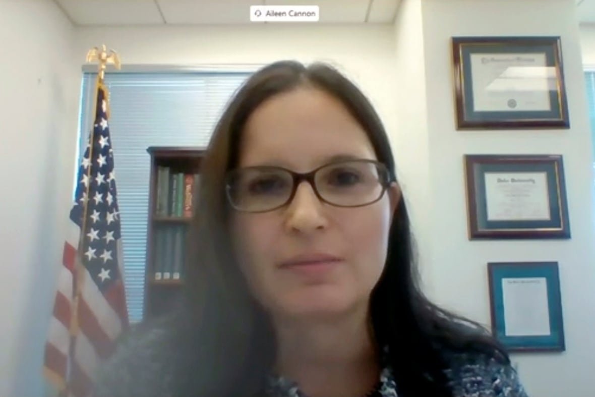 A dark haired woman wearing glasses is shown in a video still from a Zoom meeting.