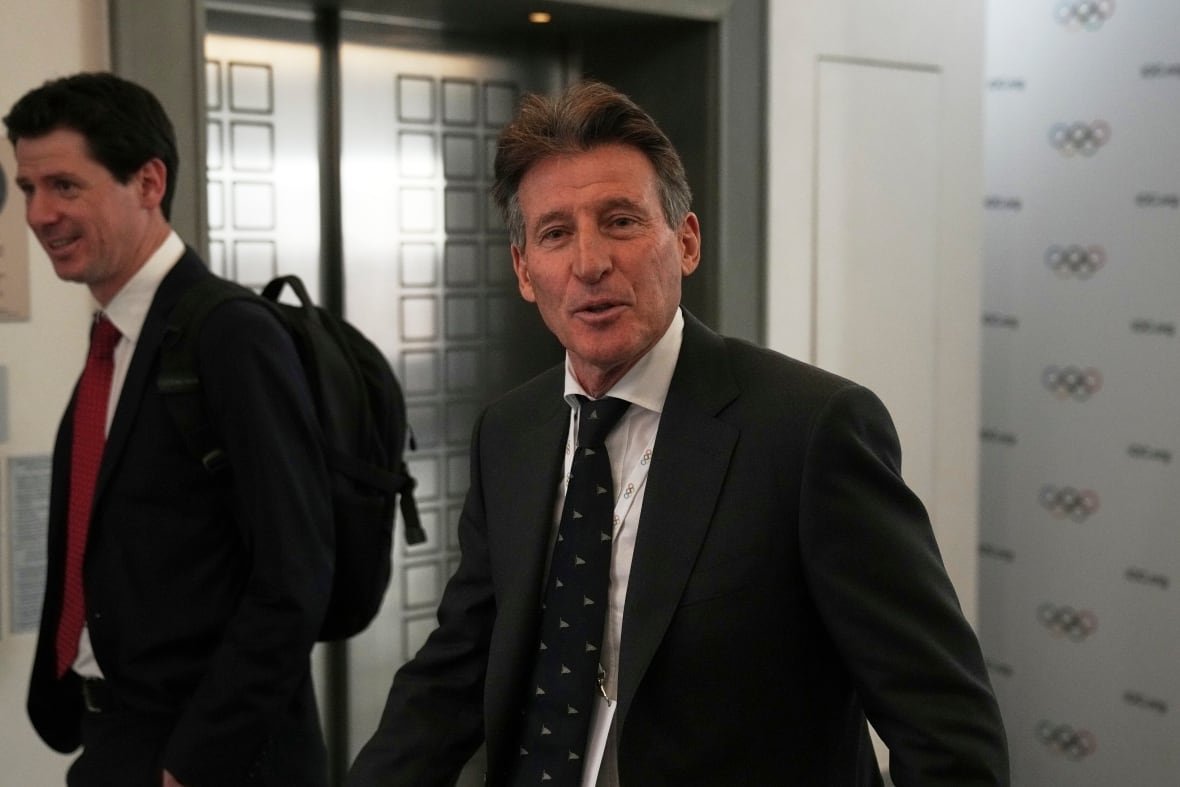 Two men in suits are pictured walking.