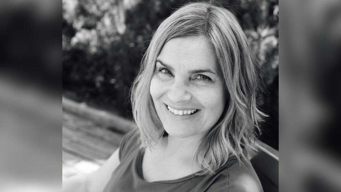 suzanne-kukko A black-and-white headshot of a person with medium-length hair, who is smiling.