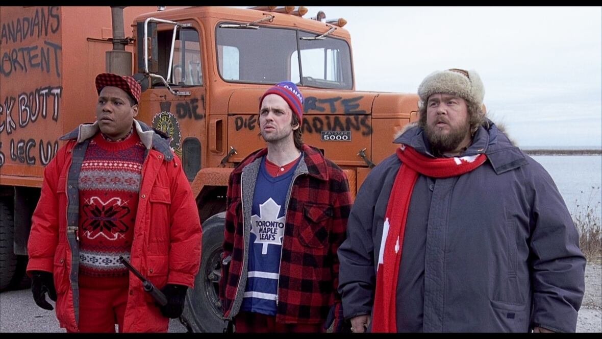 canadian-bacon-1 Three men in winter clothing.