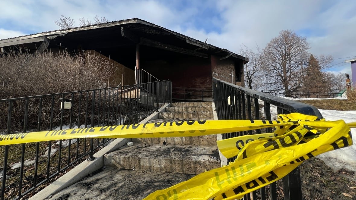 grace-st-john-s-anglican-lutheran-church-2 A building is surrounded by yellow tape after a fire.