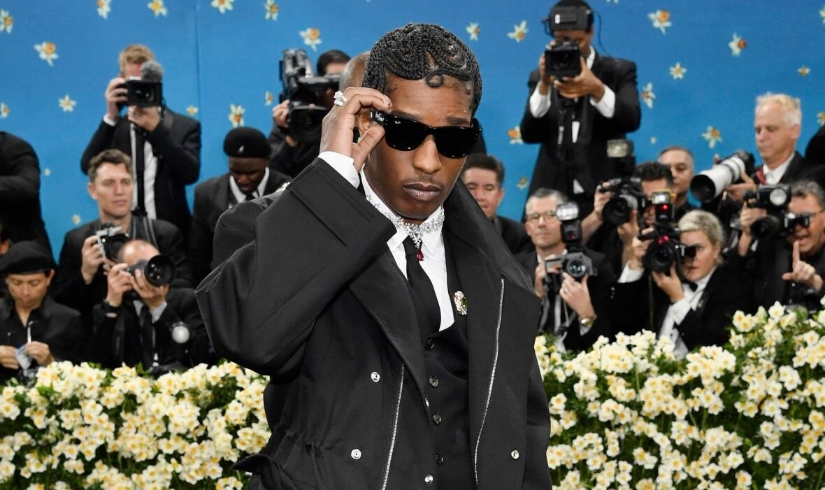 2025-met-museum-costume-institute-benefit-gala A man wearing sunglasses and an all black outfit poses for photographers. The photo shows him from the shoulders up.