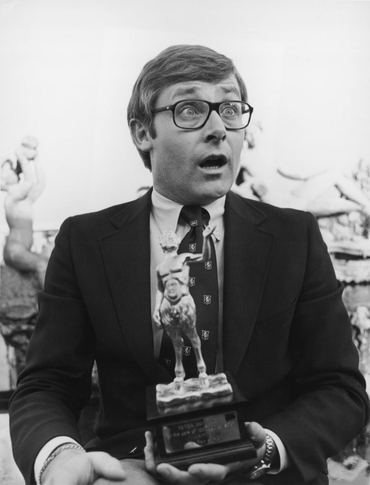 56957800-peter-benchley American author Peter Benchley makes a peculiar surprised face as he holds an award
