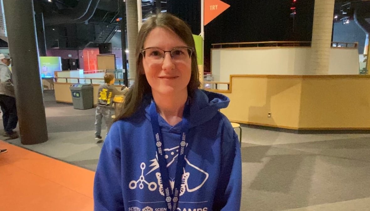 annemarie-mantione A woman wearing glasses and a blue sweater smiles.