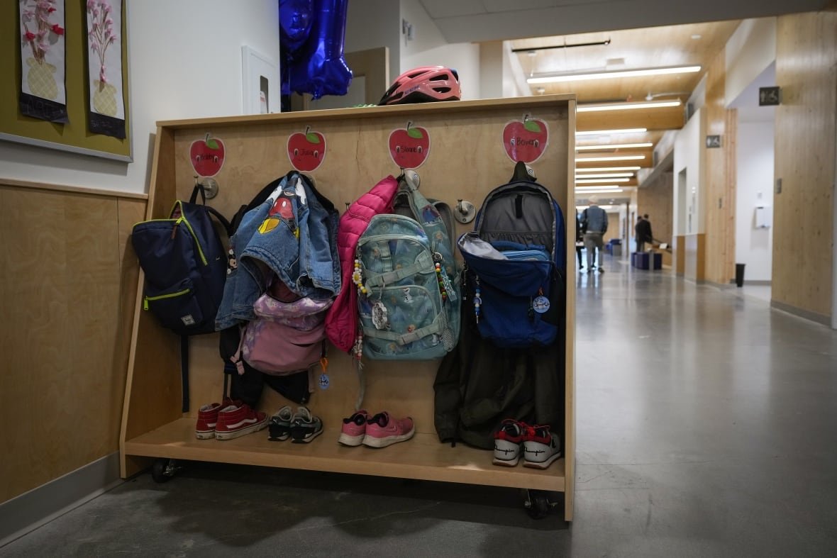 bc-school-20230413 A school hallway with jackets hanging on hooks