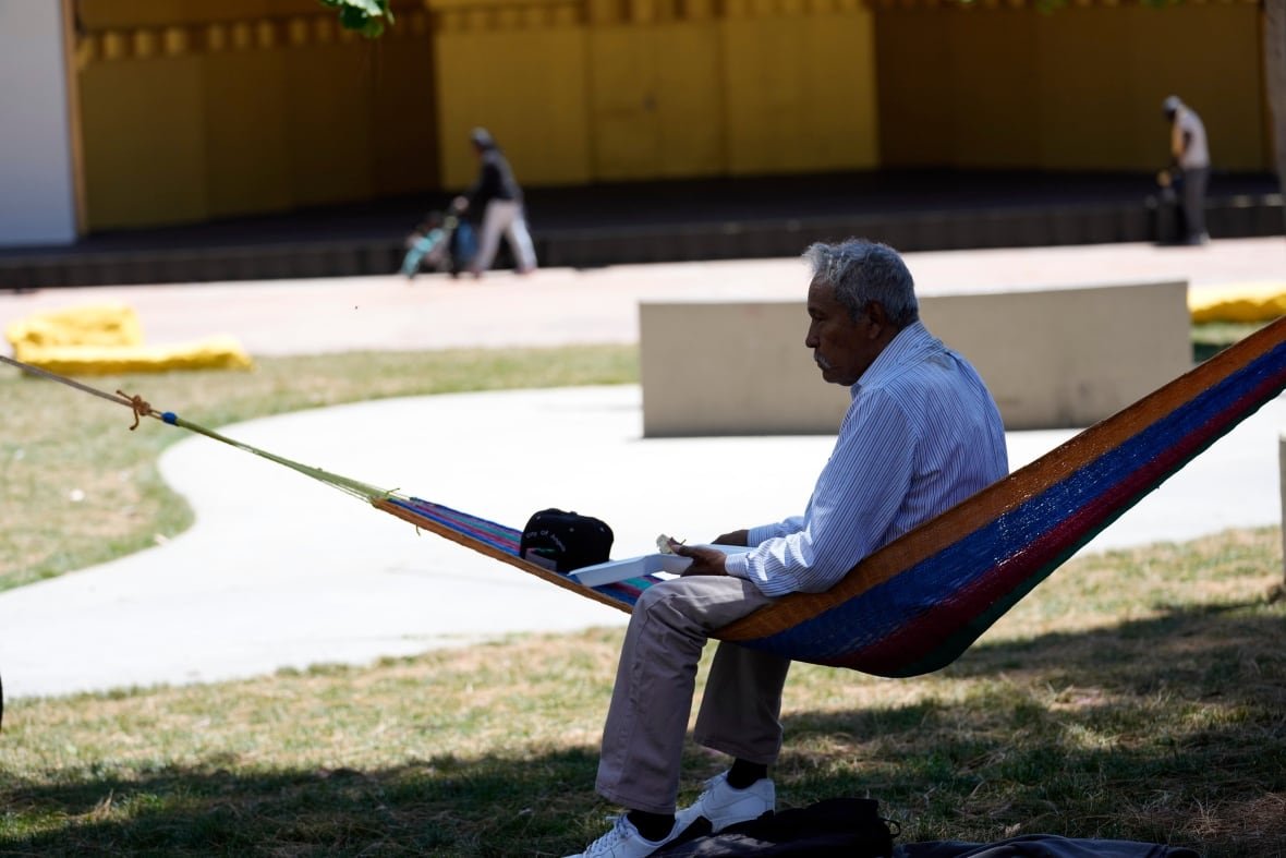 heat-wave-california-weather A man sits on a hammock under the shade of a tree as temperatures rise at MacArthur Park, Tuesday, July 11, 2023, in Los Angeles.