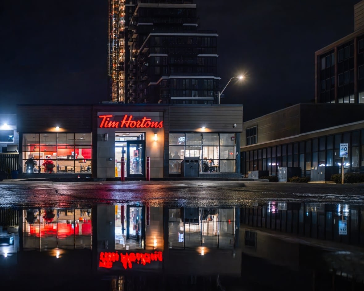 lake-timmicaca-1 A photo of tim hortons at night with puddle out front
