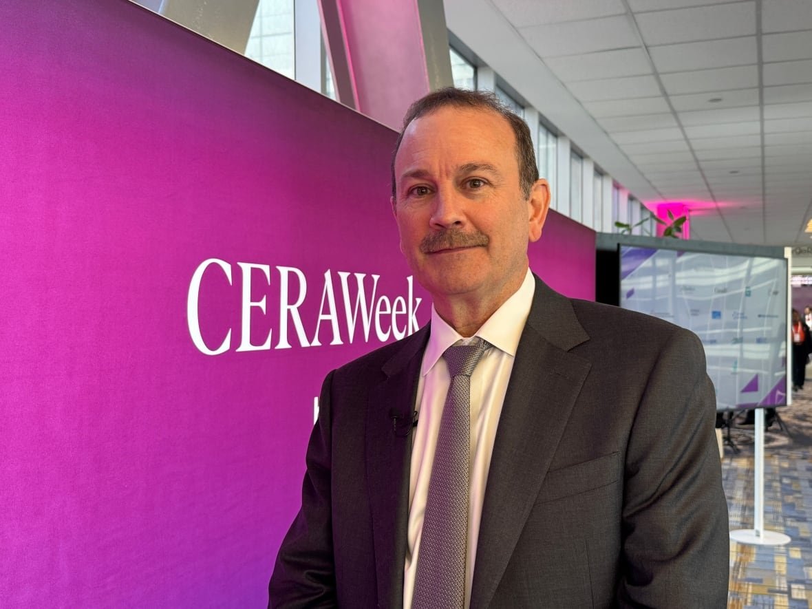mark-maki A man wearing a dark suit and grey tie is pictured in front of a purple display reading "CERAWeek" inside a hotel conference centre.