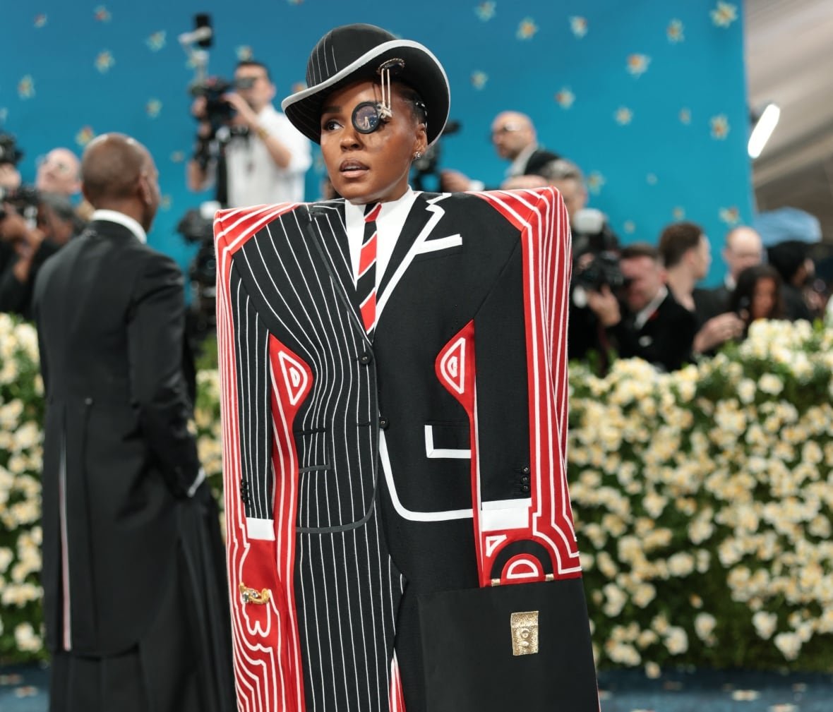usa-met-ball-6 A person stands in an outfit that is painted to look like a suit, but is shaped like a box covering them from the neck to the floor.