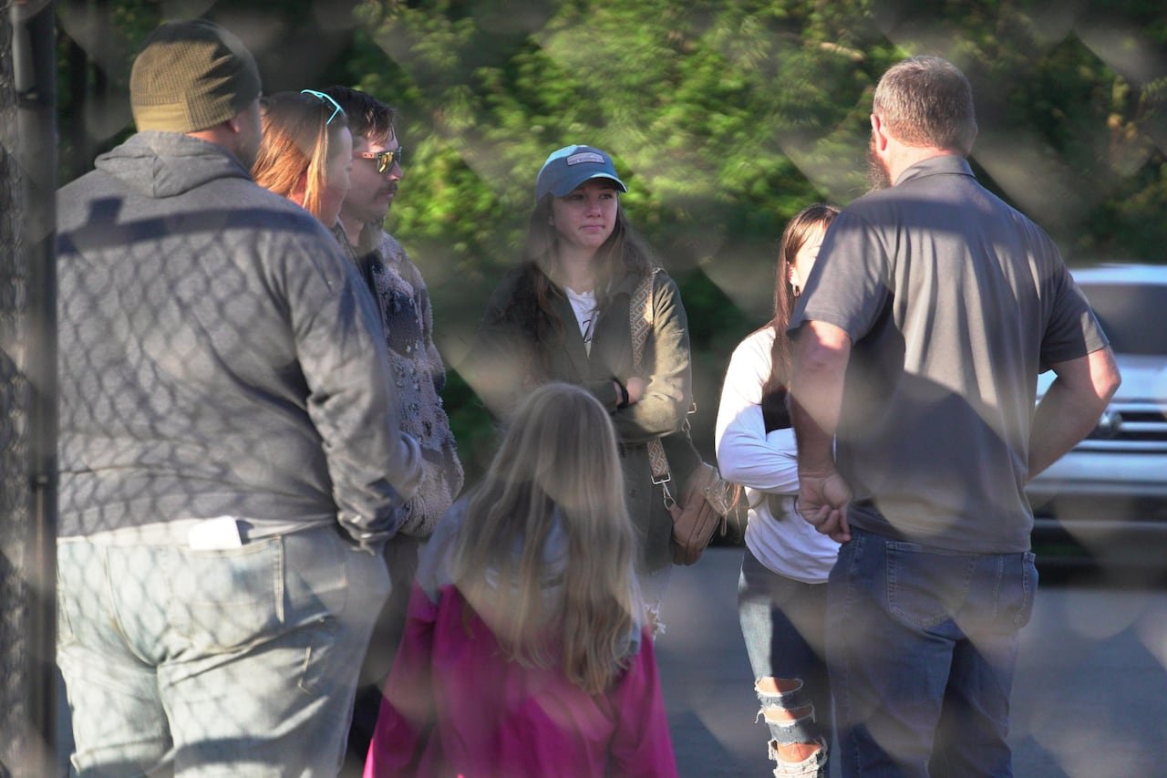 People gather in a parking lot.