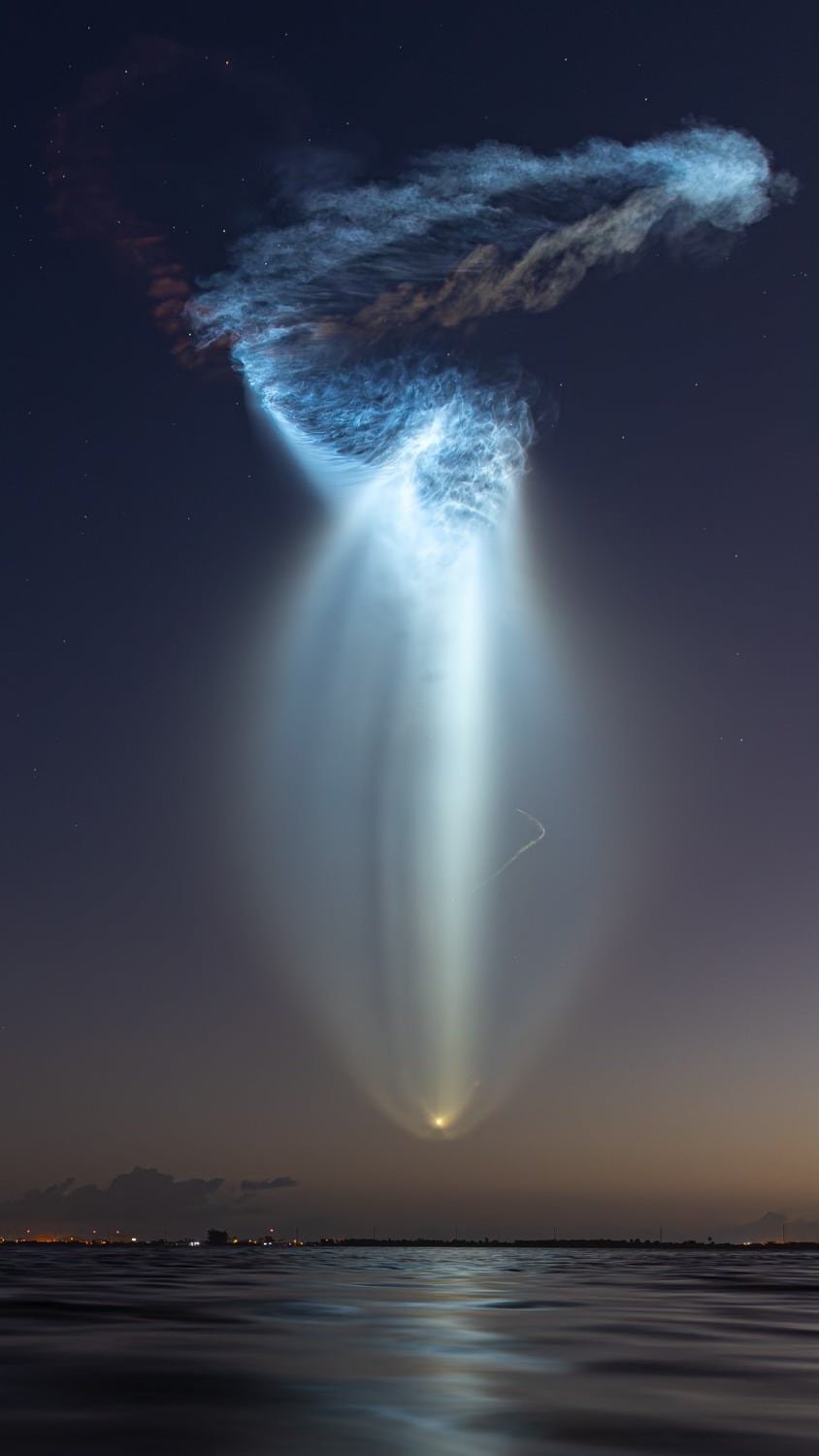 default-403 A blue plume of gases are lit by the sun over the ocean.