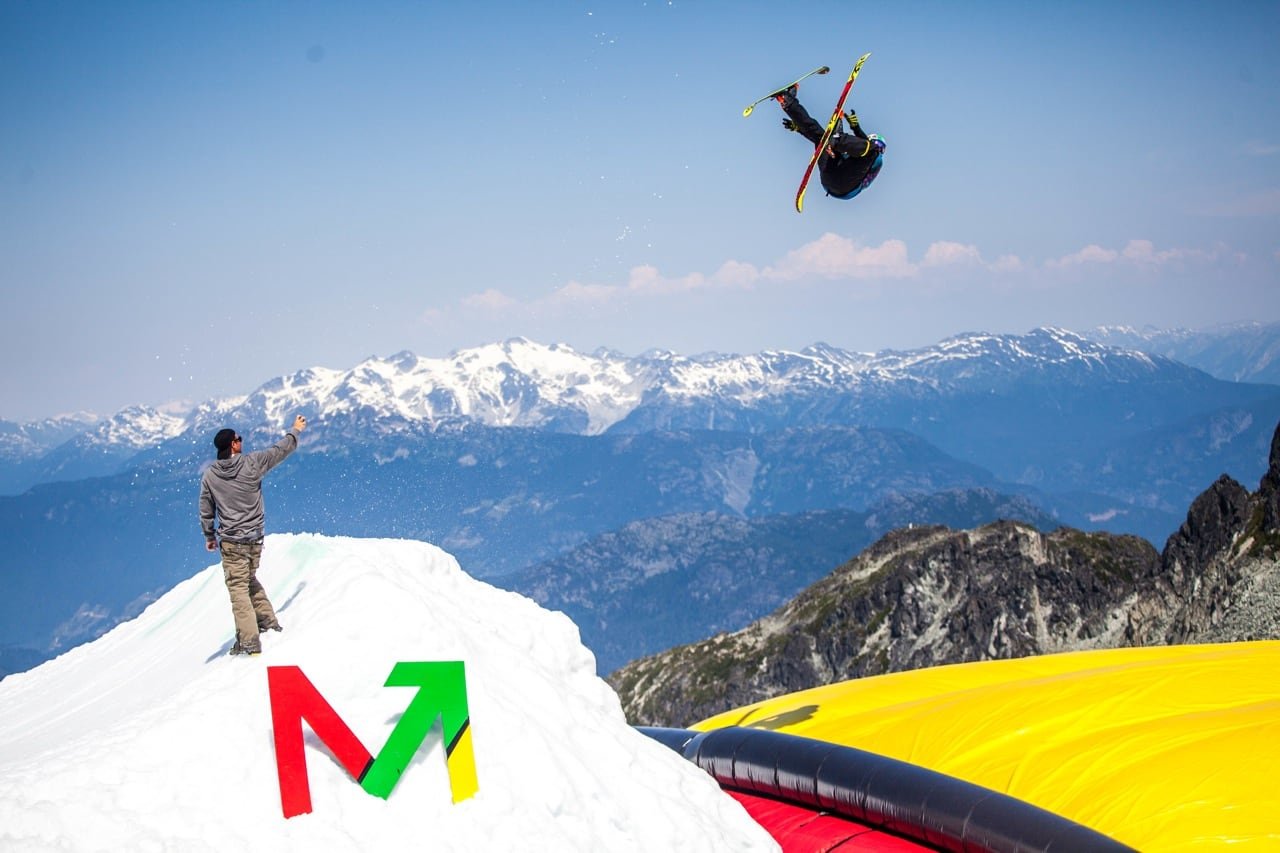 A person is watching a moguls skier on a mountain.