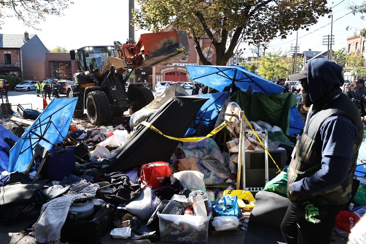 Toronto city workers clear the unhoused persons encampment at the Church of St. Stephen-in-the-Fields, in Toronto, on Oct. 16, 2025.