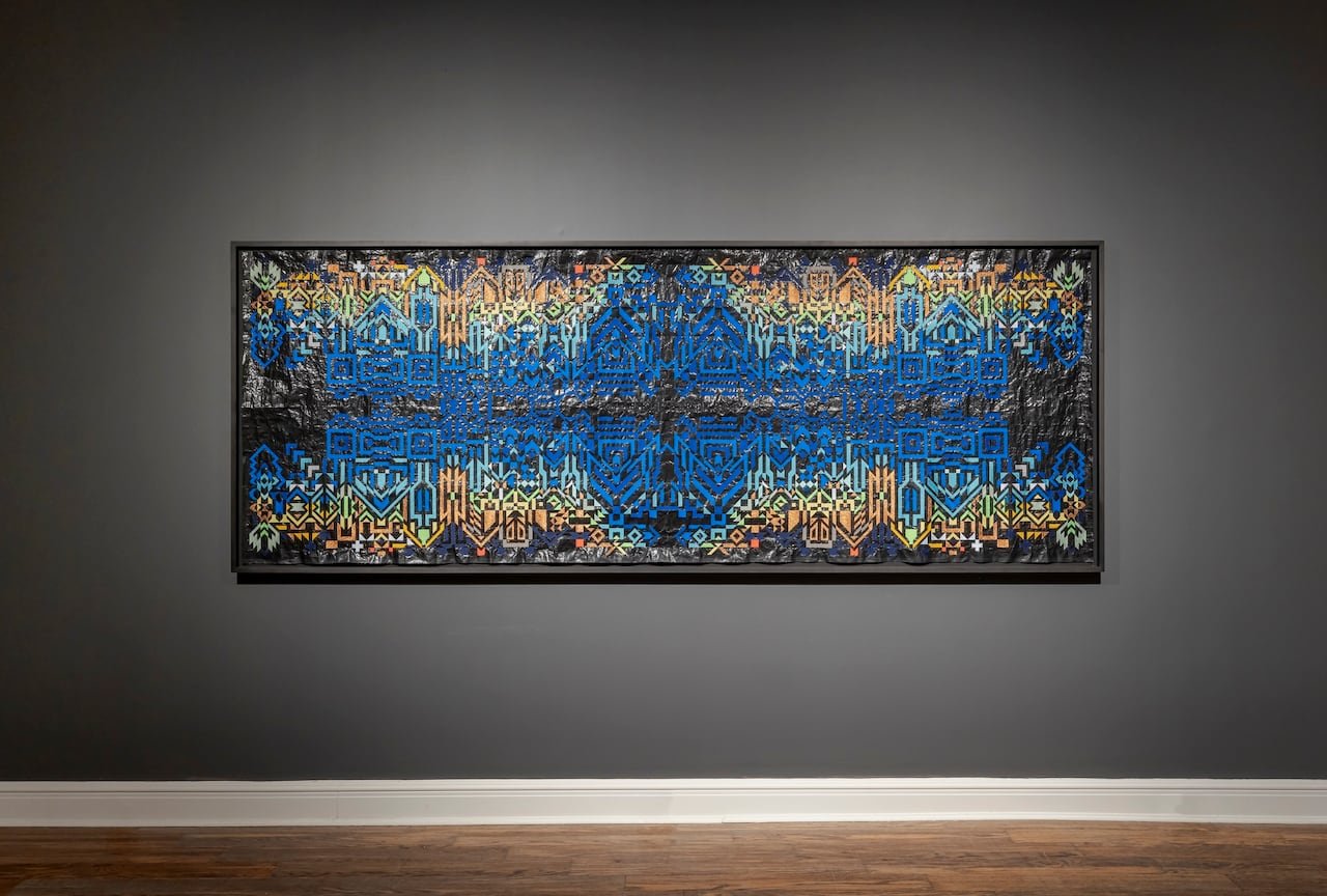 default-557 A large blue and gold embroidery hanging on a gallery wall.