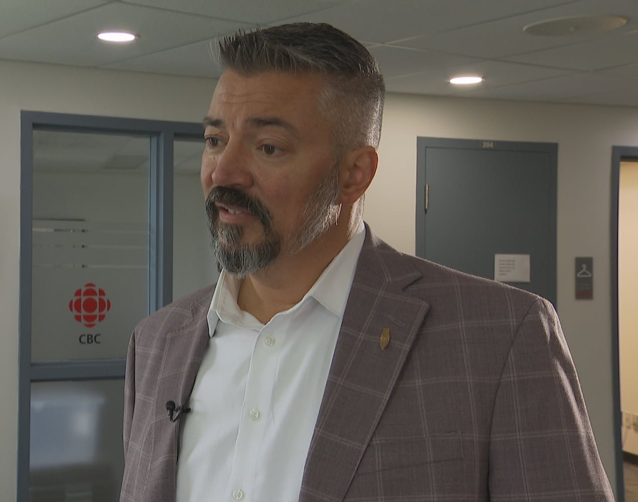 default-519 A man in a suit standing in the CBC newsroom.