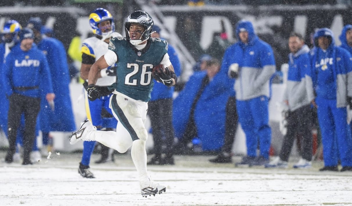 default-54 A player running with a football.